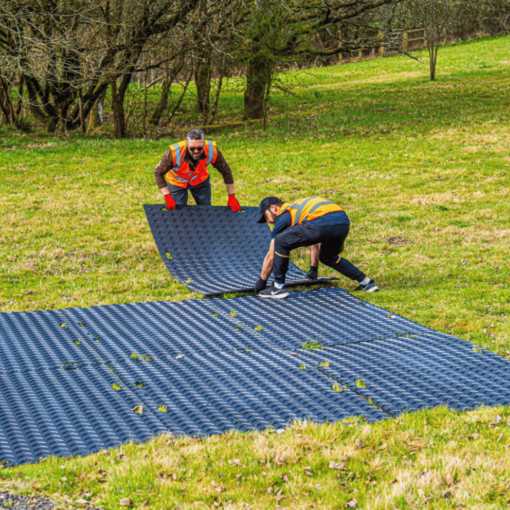GroundTuff PRO Ground Protection Mat being installed on grass for heavy-duty temporary access
