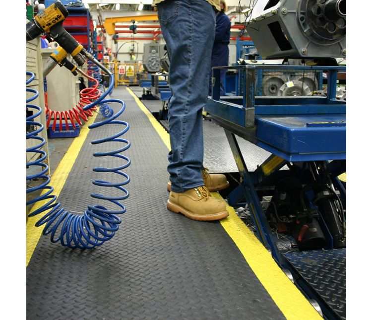 Deckplate Anti Fatigue Mat with yellow border in an industrial workstation